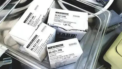 White rectangular boxes labeled burlington containing blx21 series electronic components for burlodge multigen ii blm52 returned items