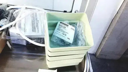A pale yellow plastic container holding a packaged baxi 270 device with tubing for burlodge multigen ii blm52 returned items
