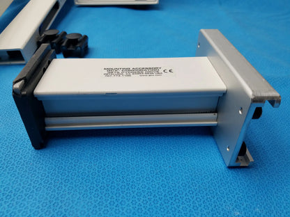 Silver and black metal wall mount accessory with white label for smiths medical equipment reuse medical equipment installation