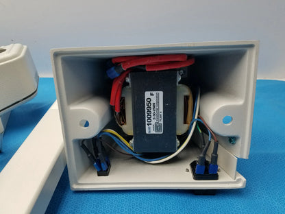 White plastic electrical enclosure housing a black transformer with red and blue wires for burton medical equipment