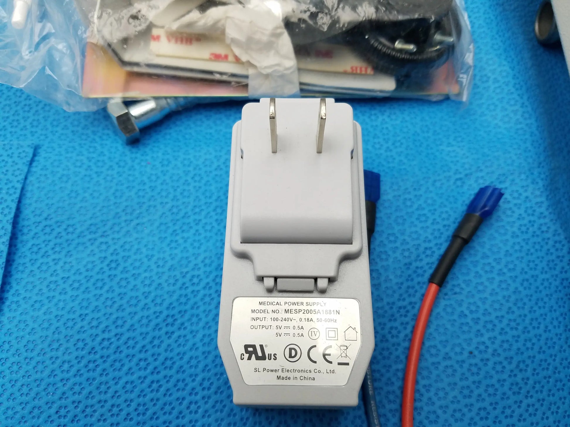 Gray plastic medical power supply adapter with model mesp2005a189in label for burton medical examination light