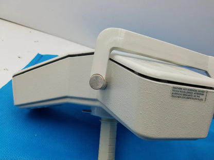 White industrial-grade burton medical outpatient ii examination light with textured finish and metallic knob is medical equipment