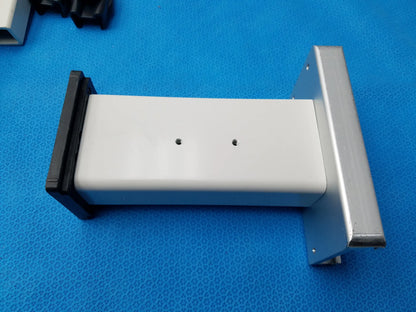 White rectangular plastic housing with black and silver metal brackets for burton medical outpatient ii examination light wall mount assembly