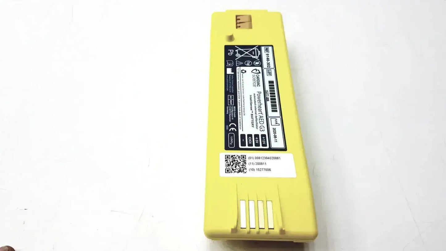 Yellow rectangular cardiac science intellisense lithium battery with black labeling and white qr code for powerheart g3 aed