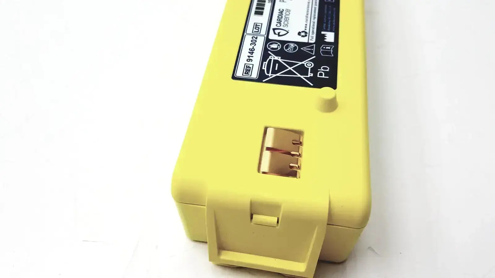 Yellow plastic cardiac science intellisense lithium battery with black label and gold contacts for powerheart g3 aed