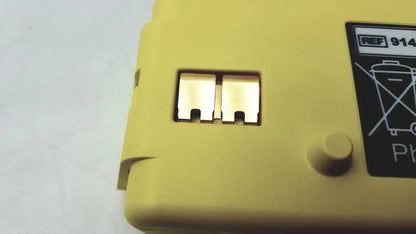 Yellow plastic cardiac science intellisense lithium battery with metallic terminals and recycling label for powerheart g3 AED