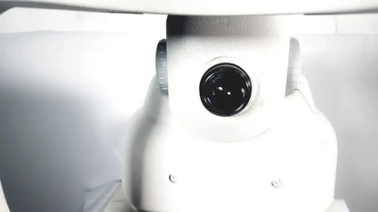 White robotic camera with black lens and metallic dial on zeiss stratus oct model 3000 patient module for imaging