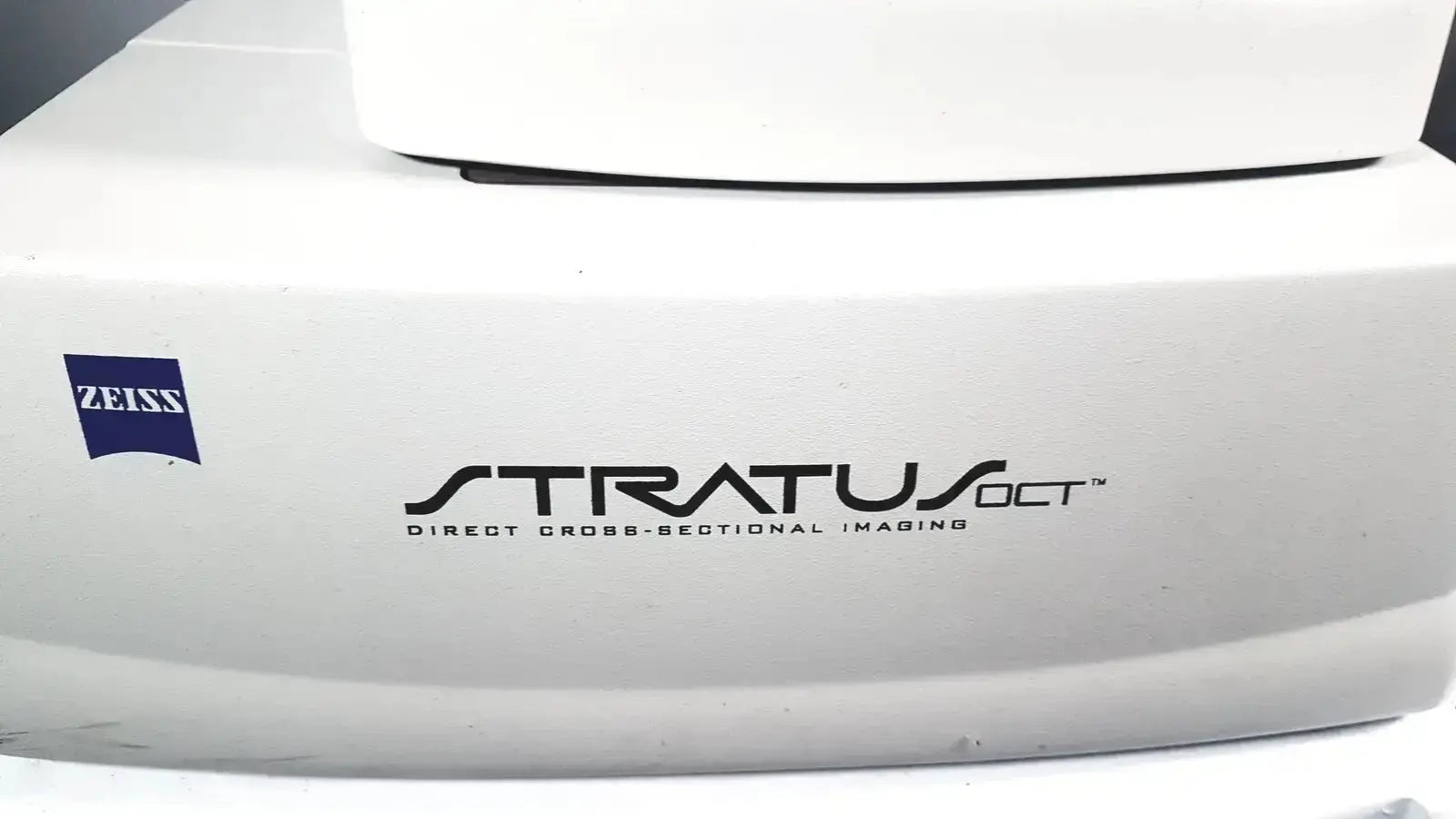 White Carl Zeiss Stratus OCT Model 3000 Direct Cross-Sectional Imaging patient module with black lettering and logo