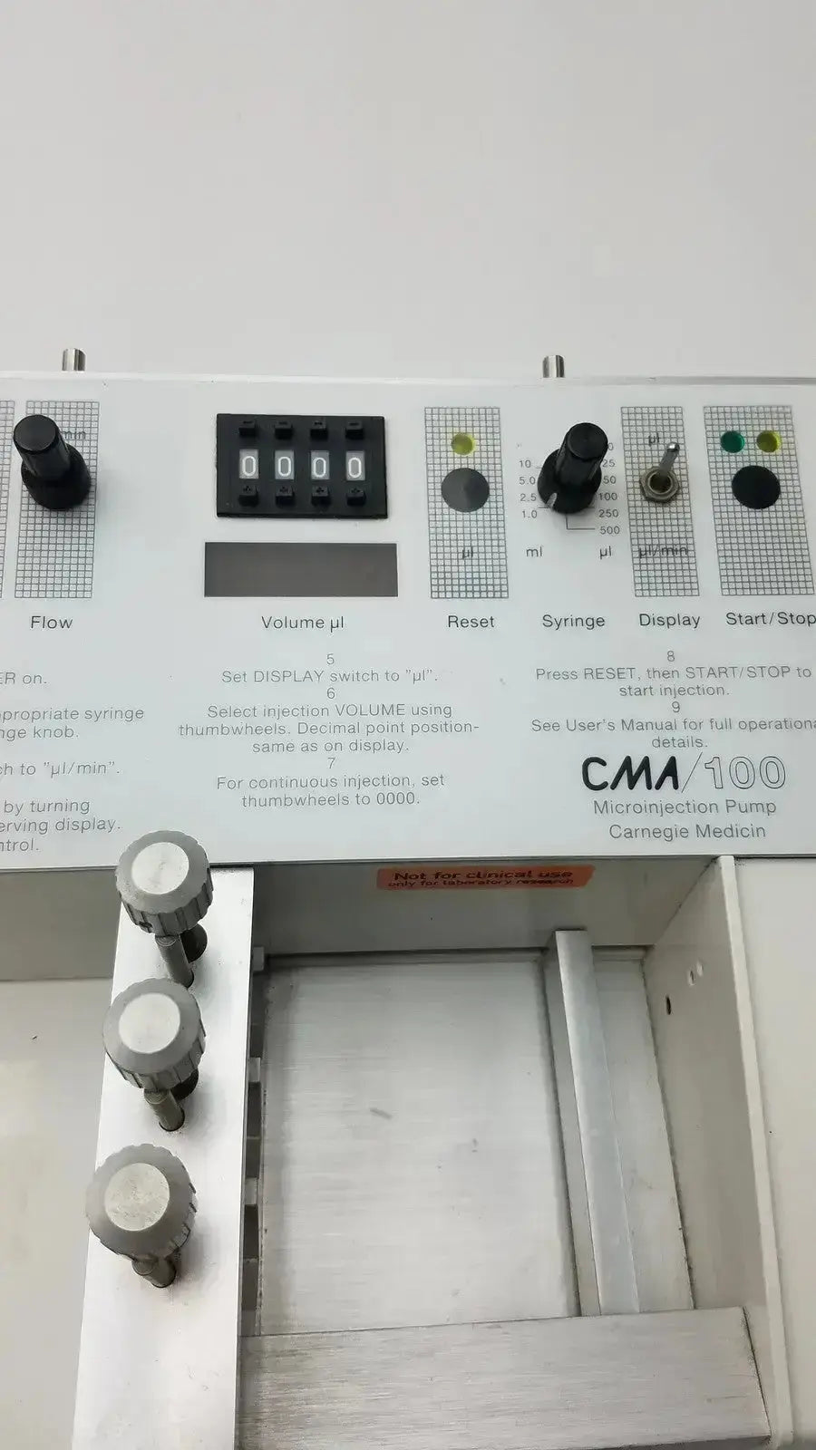 White cma 100 microinjection pump by carnegie medicin ab with black digital display and gray control knobs