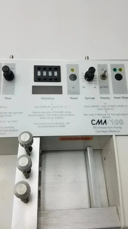 White cma 100 microinjection pump by carnegie medicin ab with black digital display and gray control knobs