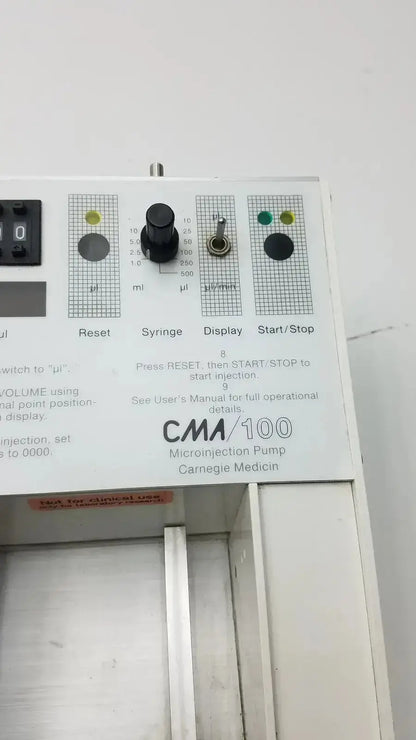White carnegie medicin ab model cma 100 microinjection pump with black control knobs and green indicator lights
