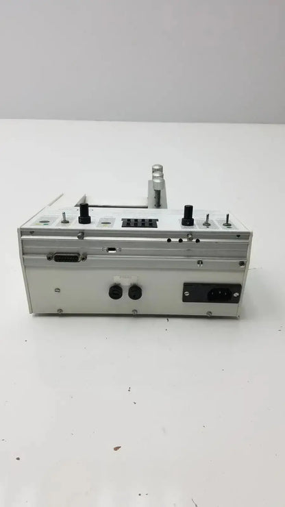 Silver metallic microinjection pump with black knobs and ports Carnegie Medicin AB model CMA 100 industrial device