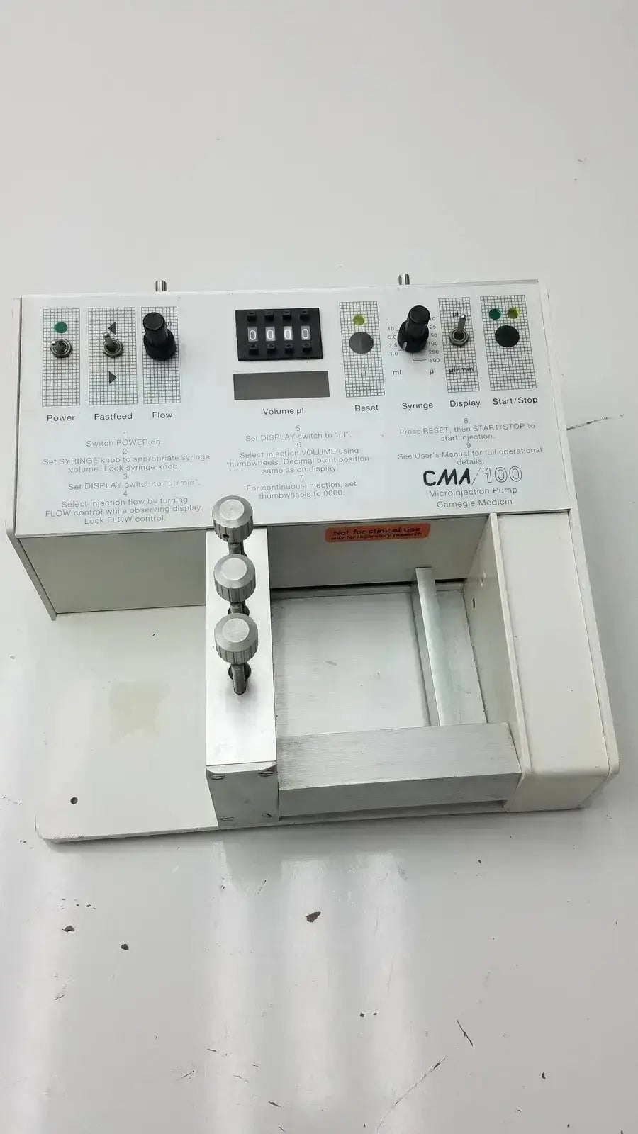 White carnegie medicin ab model cma 100 microinjection pump with black knobs digital display and labeled control panels