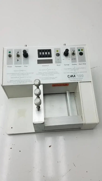 White carnegie medicin ab model cma 100 microinjection pump with black knobs digital display and labeled control panels