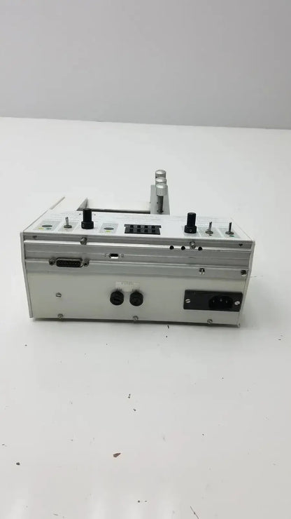 Silver metallic carnegie medicin ab model cma 100 microinjection pump with black knobs and ports in compact design