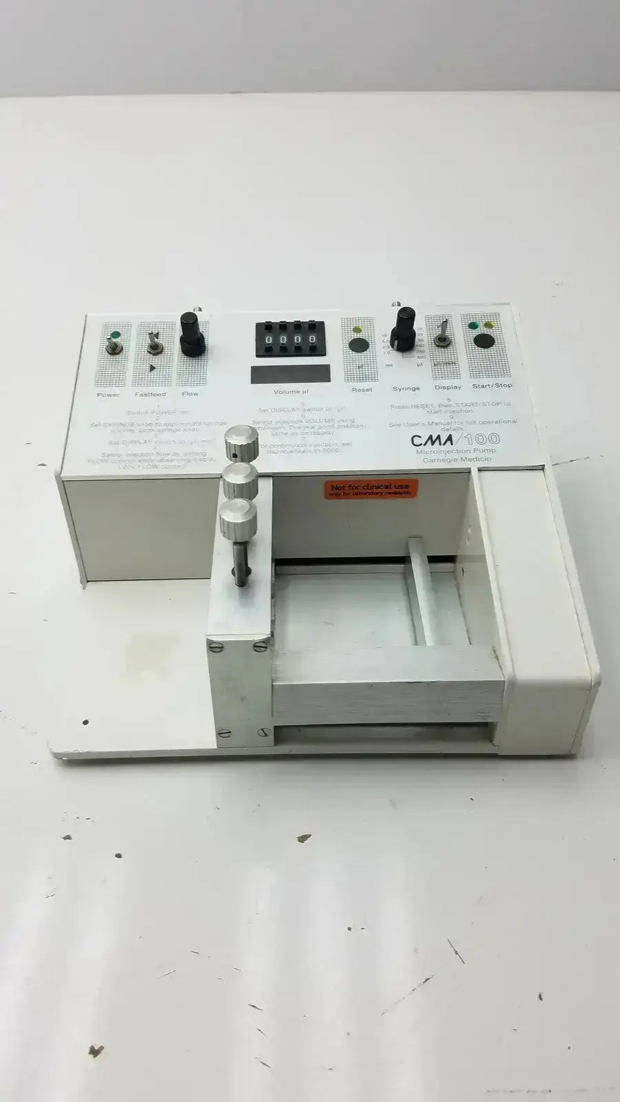 White carnegie medicin ab model cma 100 microinjection pump with black knobs digital display and metallic dials