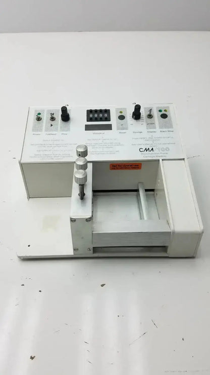White carnegie medicin ab model cma 100 microinjection pump with black knobs digital display and metallic dials