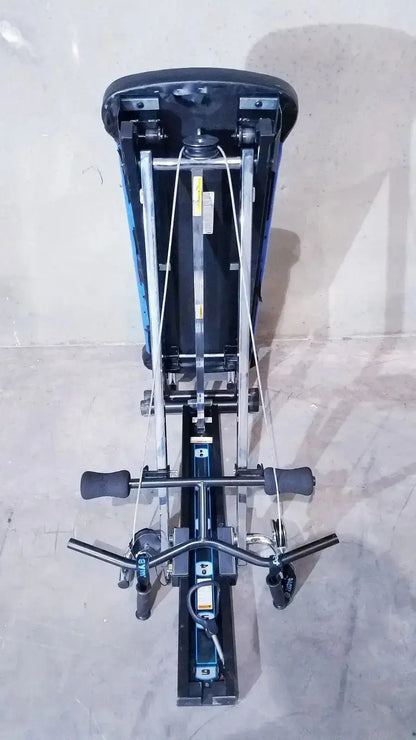 Blue and black adjustable total gym xls with metal frame, padded seat, resistance cables, and foot stand