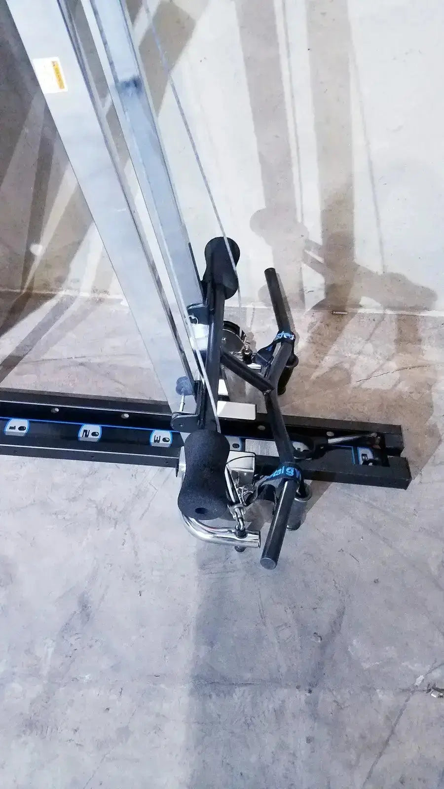 Black and silver cable row machine with adjustable resistance from chuck norris total gym xls with foot stand wing bar