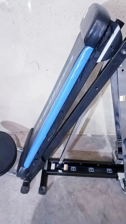 Black and blue adjustable total gym xls weight bench with padded seat and backrest featuring foot stand and wing bar