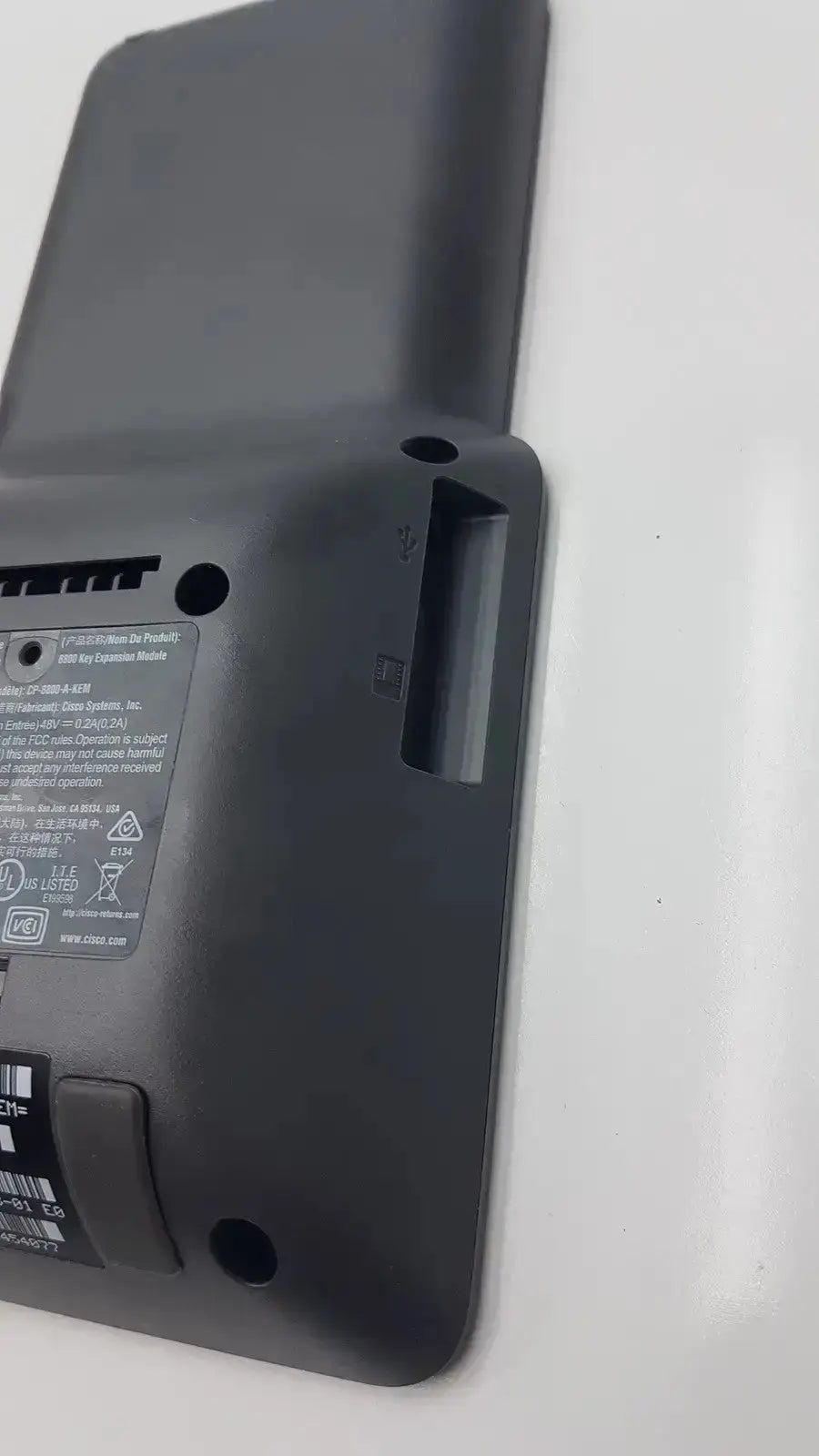 Black plastic expansion module with matte finish showing labeled specifications on back for cisco 8800 series kem audio cp-8800-a-kem