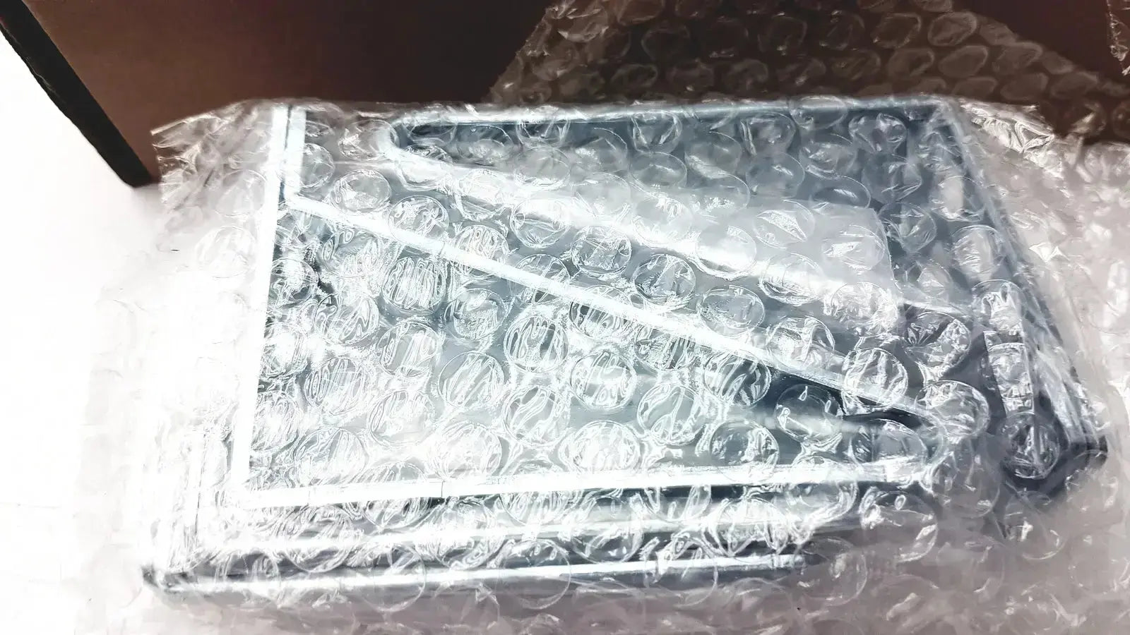 Silver-framed rectangular metal rack mount kit brackets wrapped in bubble wrap for cisco catalyst 3850 rack mount