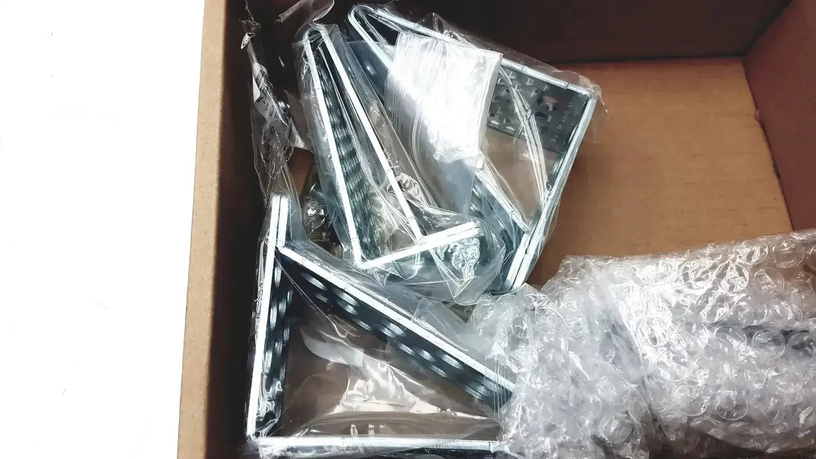 Silver-framed led light panels in clear plastic packaging with bubble wrap inside a box for cisco catalyst 3850 rack mount kit