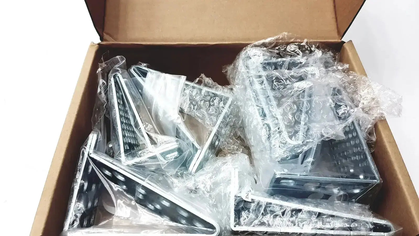 Silver triangular shelf brackets wrapped in bubble wrap inside a box for cisco catalyst 3850 rack mount kit