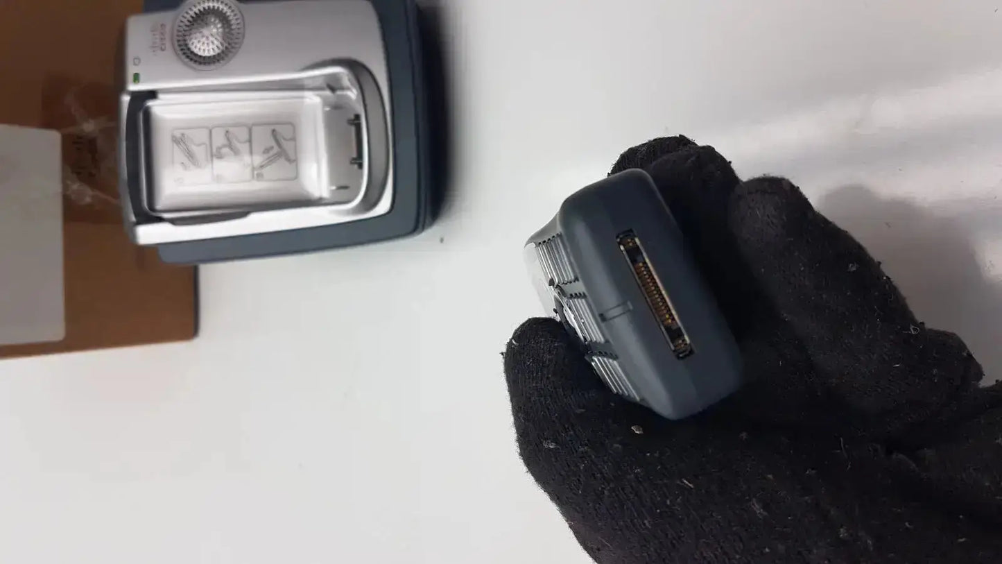Dark gray plastic handheld cisco cp-7921g-a-k9 wireless phone showing side rectangular connector port