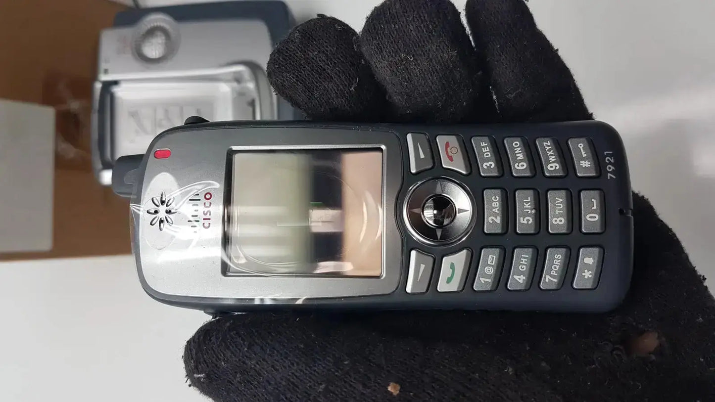 Black and silver cisco cp-7921g-a-k9 wireless phone with small screen numeric keypad and central navigation button