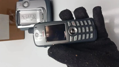 Black and silver cisco cp-7921g-a-k9 wireless ip phone with numeric keypad, circular navigation button, and small screen
