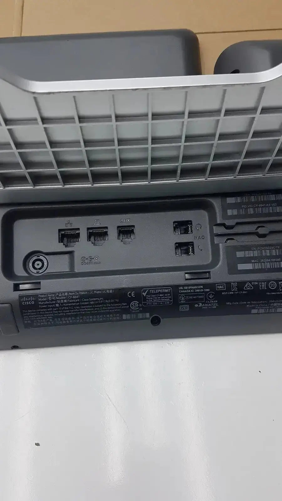 Back side of gray plastic Cisco CP-8841 IP phone color voip poe with silver trim and ethernet usb power ports