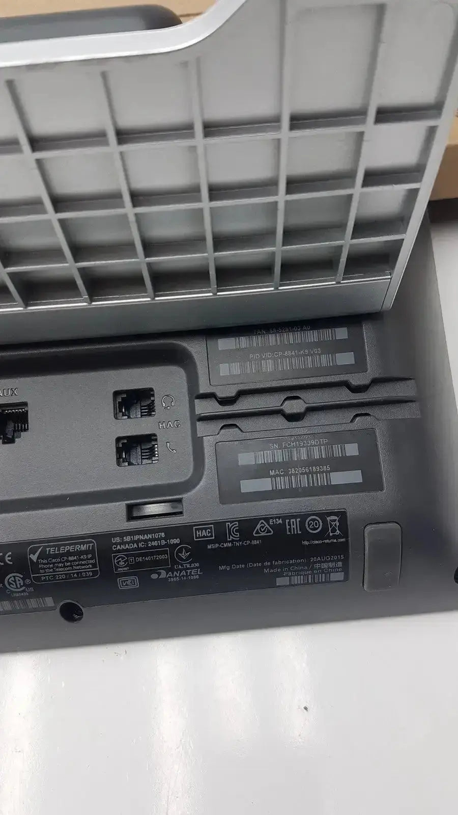 Underside of gray plastic cisco cp-8841 ip phone color voip poe showing ethernet ports and regulatory labels