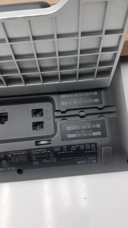 Underside of gray plastic cisco cp-8841 ip phone color voip poe showing ethernet ports and regulatory labels