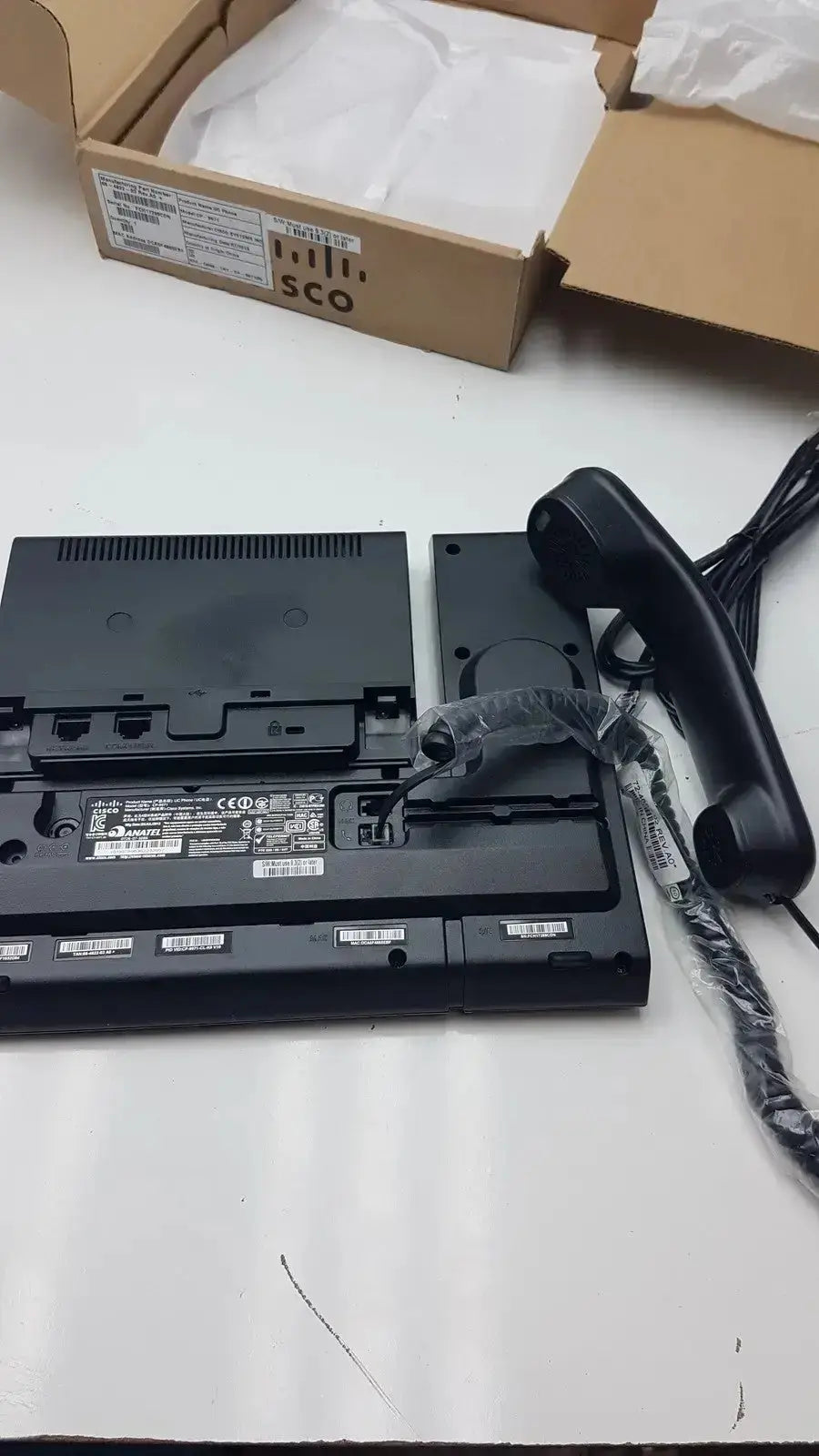 Black plastic Cisco CP-9971 color office phone with handset and cables for professional office phone use