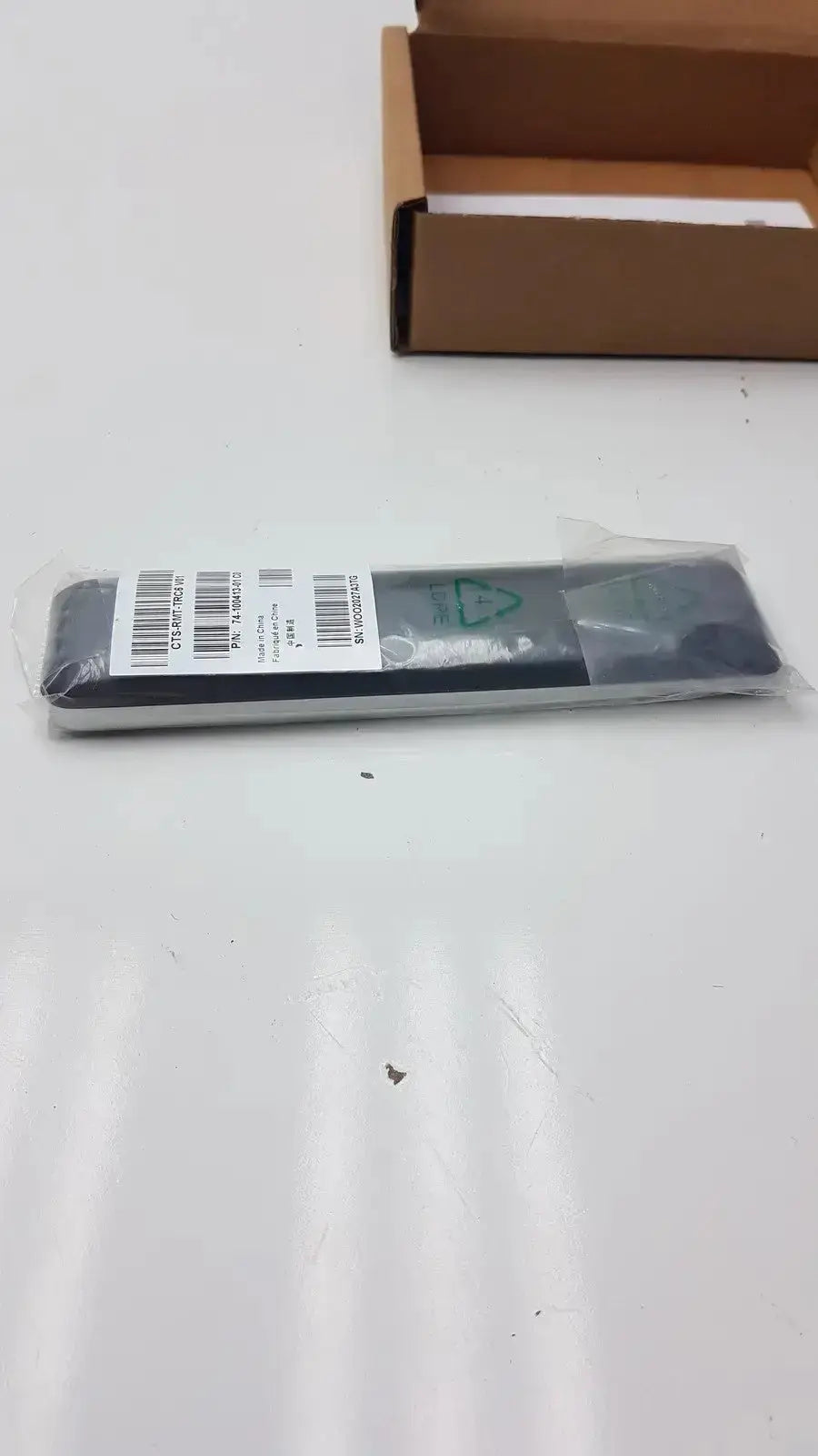 Gray cisco cts-rmt-trc6 remote control in clear plastic packaging with barcode label for telepresence cts-sx20n