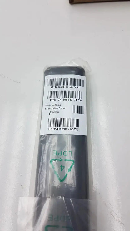 Black plastic cisco cts-rmt-trc6 remote control wrapped in clear packaging with white label and product barcodes