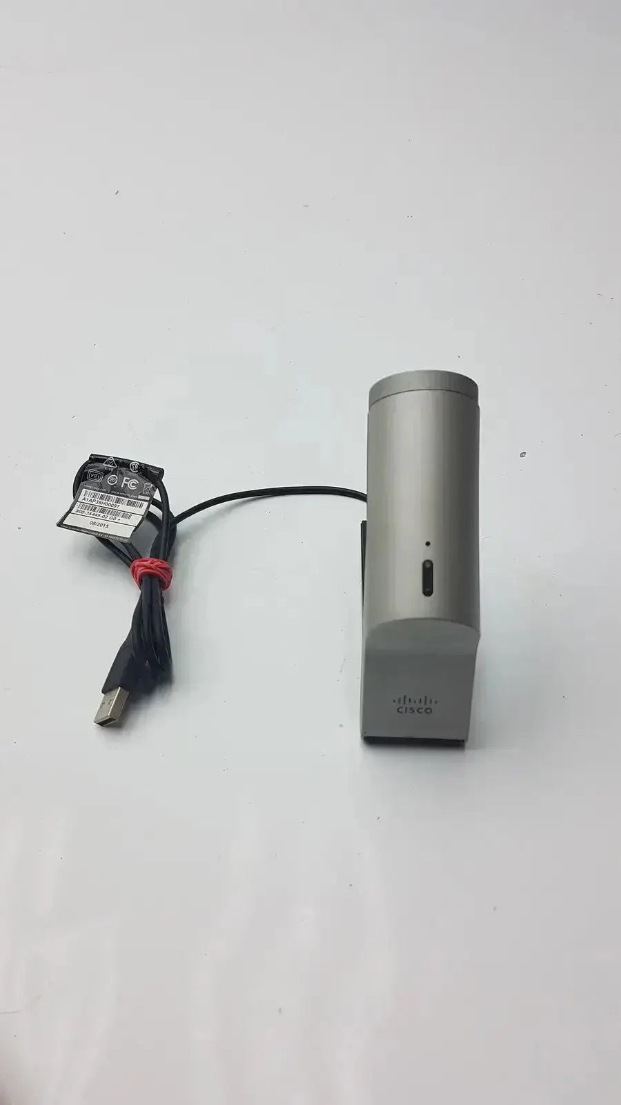 Silver cisco telepresence precisionhd wireless router with black usb cable and label attached for telepresence use