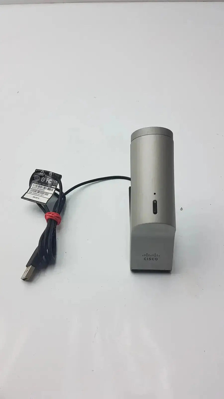 Silver cisco telepresence precisionhd ip phone base with sleek cylindrical design and matte finish for professional use