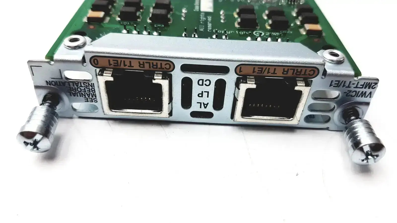 Silver metallic cisco vwic2 2mft-t1 e1 2-port voice wan card with two ethernet ports and green circuit board background