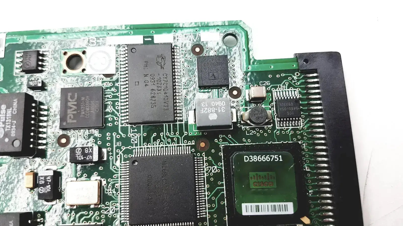 Green circuit board with black integrated circuits and silver solder points in cisco vwic2 2mft-t1 e1 2-port voice wan module
