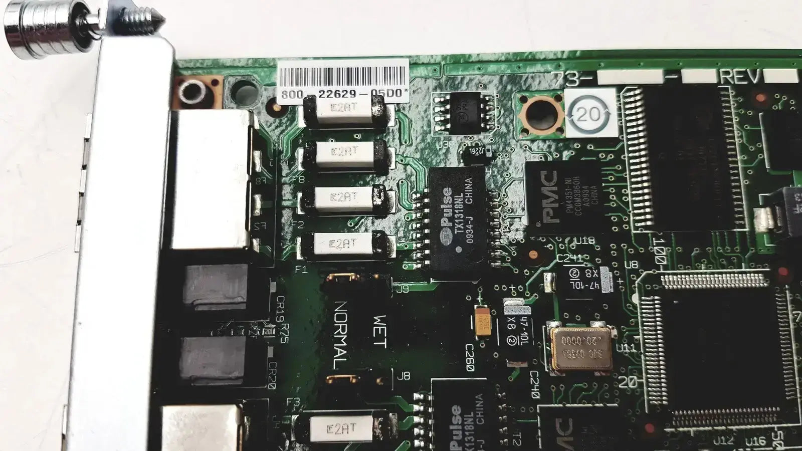 Green circuit board with black integrated circuits and silver connectors of cisco vwic2 2mft-t1 e1 2-port voice wan module