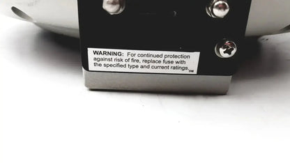 Black rectangular electronic component with three silver screws and warning label on the back of clay adams becton dickinson sero-fuge 2001 centrifuge