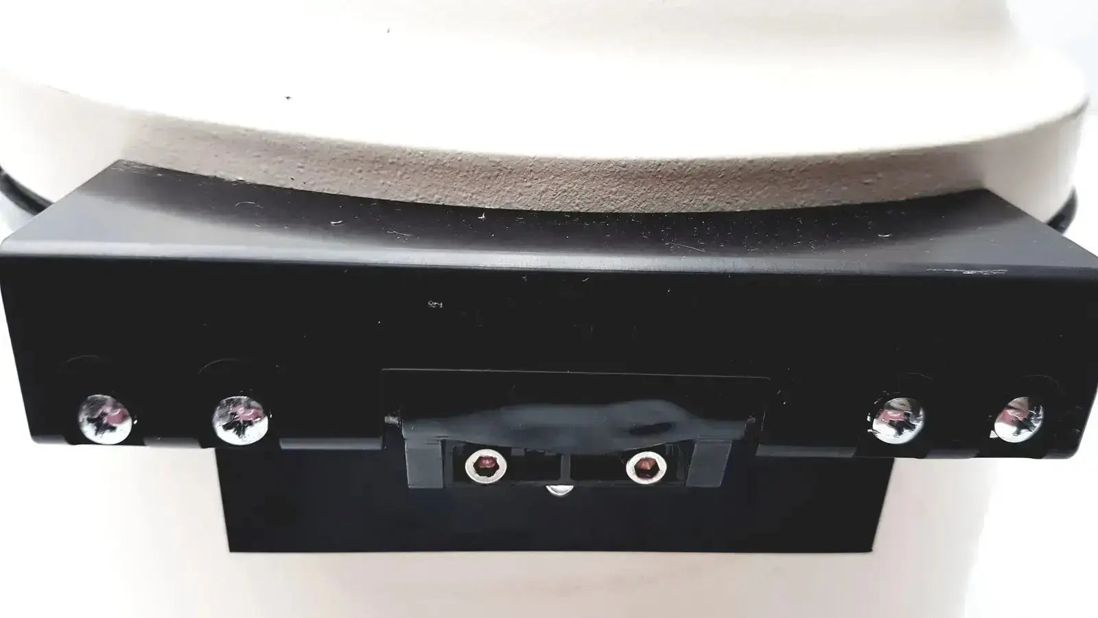 Black rectangular base with silver screws and two circular ports on the back of a clay adams becton dickinson sero-fuge 2001 centrifuge