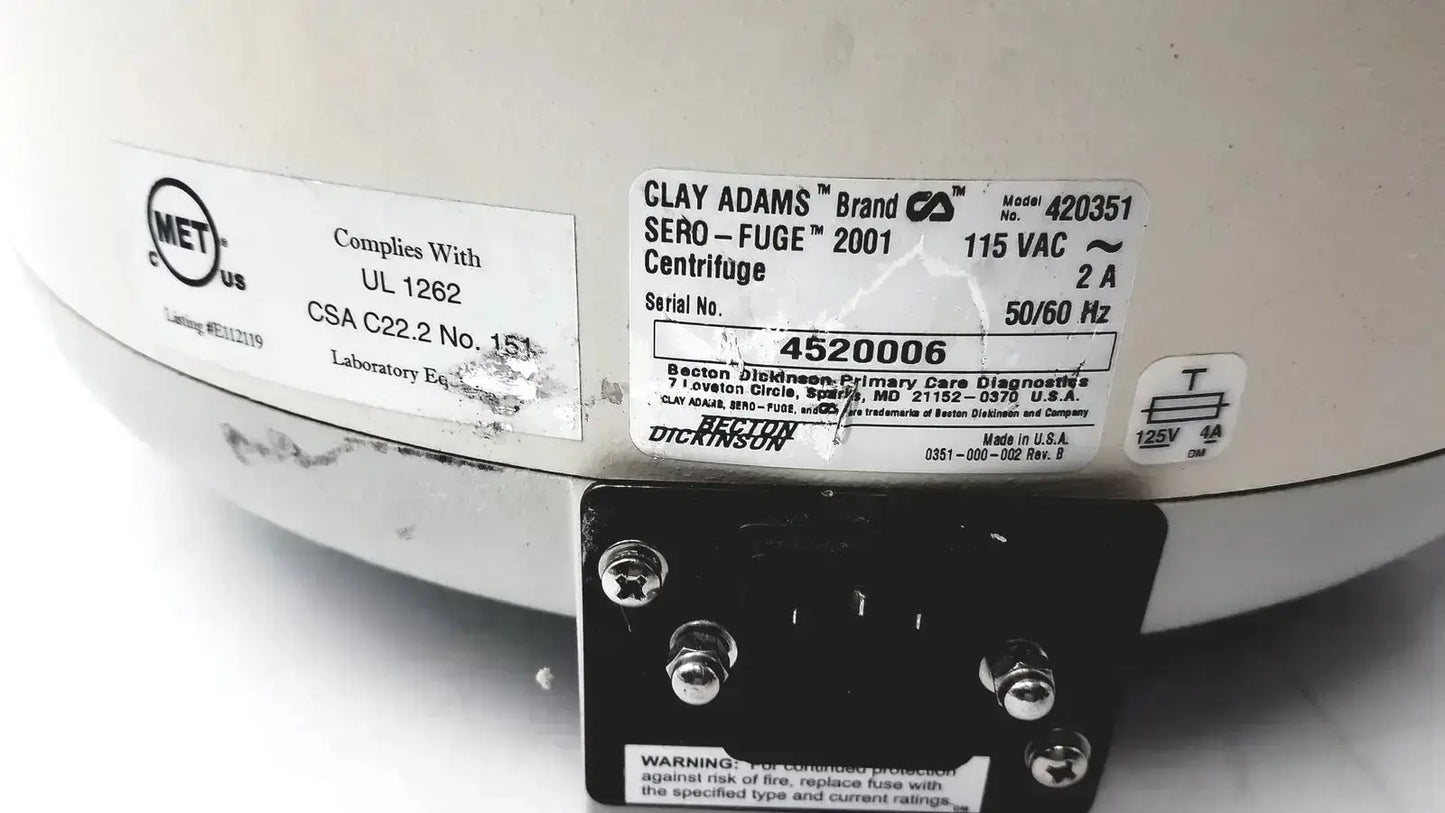 White ceramic Clay Adams benchtop centrifuge model 420351 with black metal base and labeled specifications