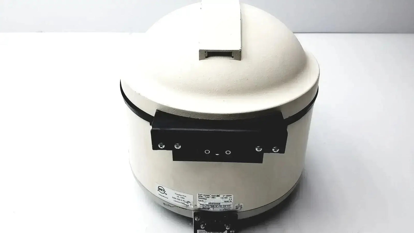 Cream-colored ceramic benchtop centrifuge model clay adams sero-fuge 2001 with black handle and base
