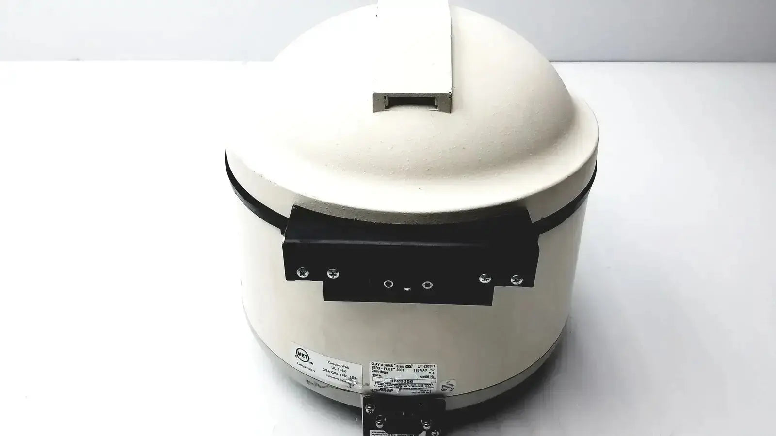 Cream-colored ceramic benchtop centrifuge model clay adams sero-fuge 2001 with black handle and base