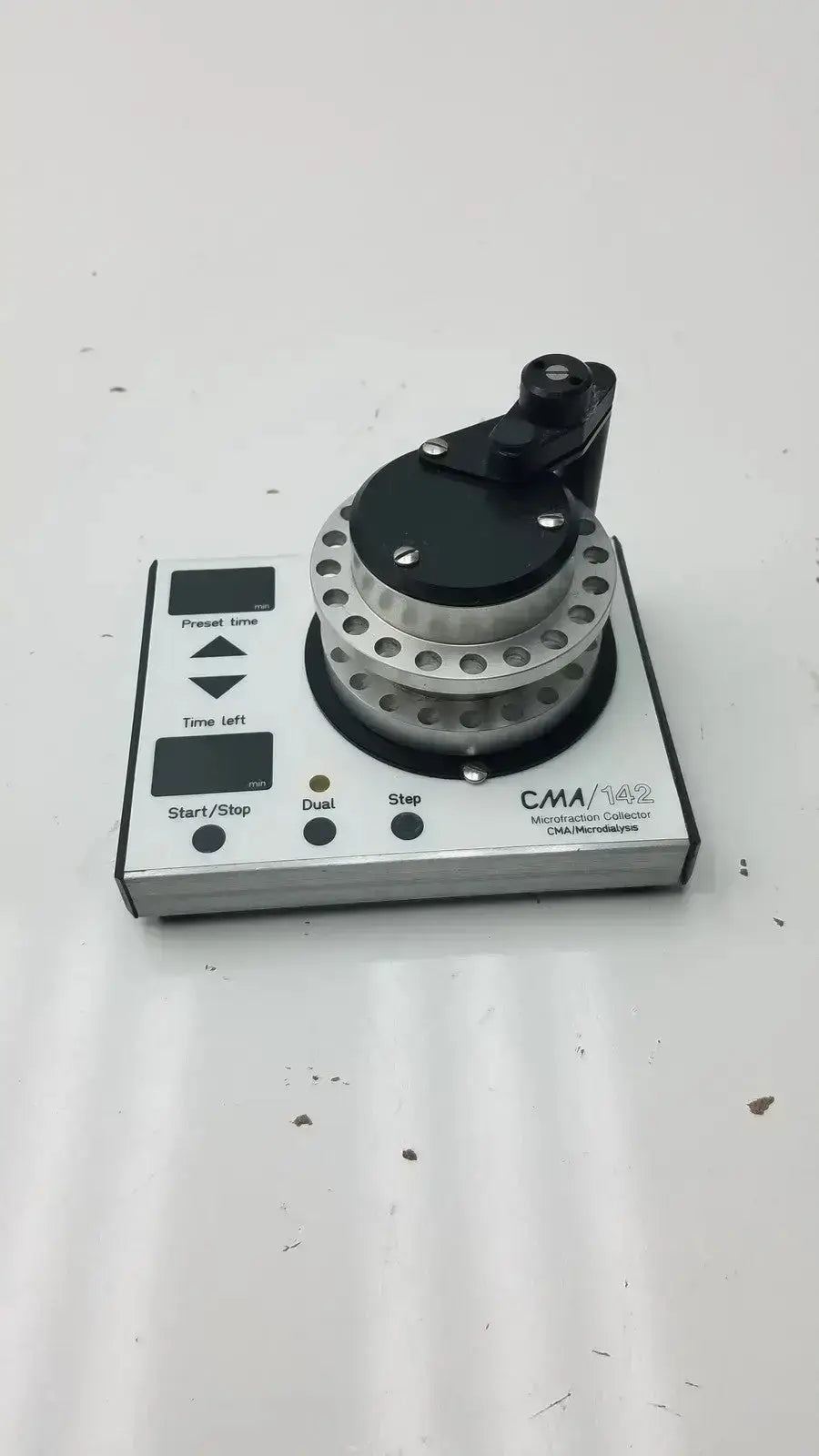 Silver and black cma microfraction collector model 142 with circular dial featuring multiple holes for precise microfraction control
