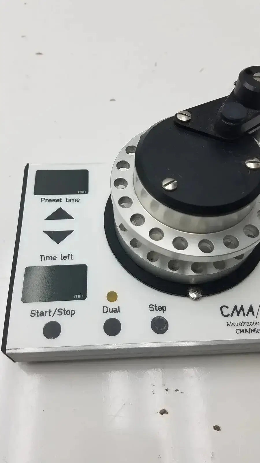 Cma microfraction collector model 142 featuring a white body with a silver and black rotating component for precise fractionation