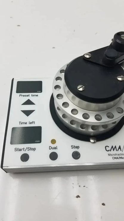 Cma microfraction collector model 142 featuring a white body with a silver and black rotating component for precise fractionation